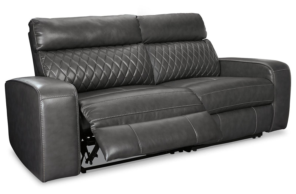 Gray power reclining sofa with padded arms and recline footrest on metal base