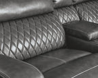 Gray power reclining sectional with diamond-quilted back and padded arm recline panel
