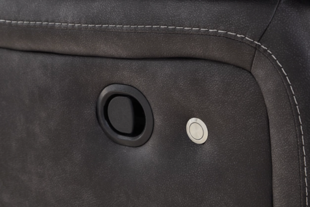 Dark carbon sofa control panel on the armrest with circular buttons and recessed handle.