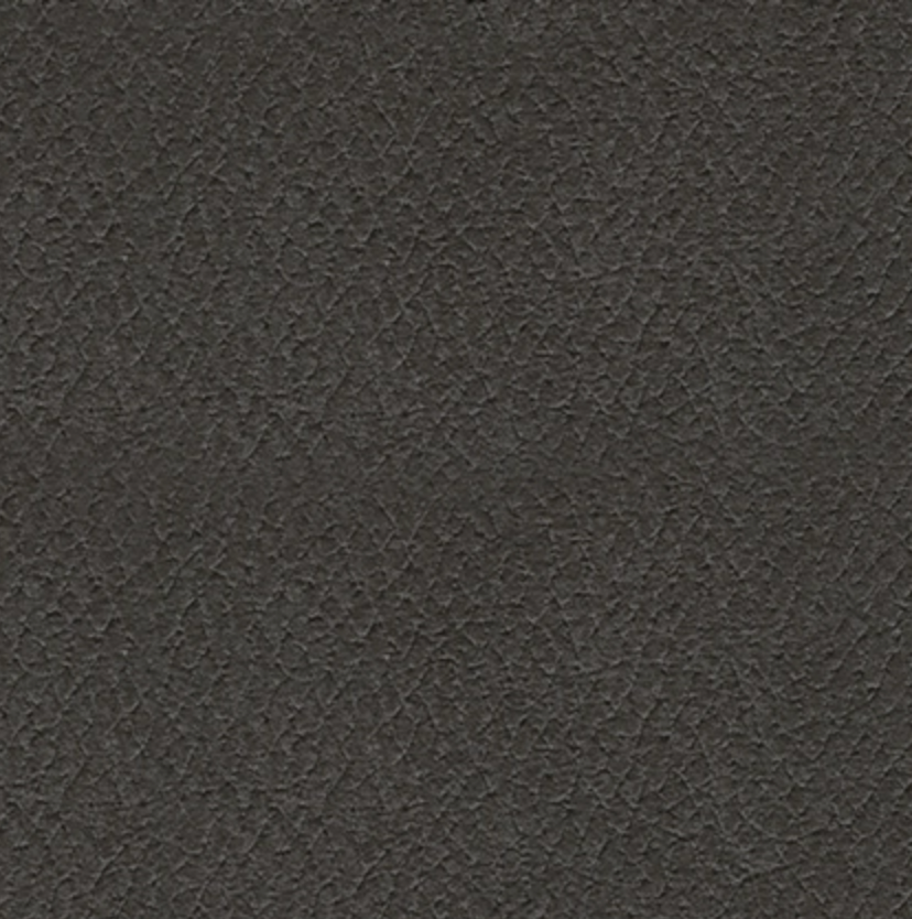 Close-up of dark carbon faux-leather upholstery texture.
