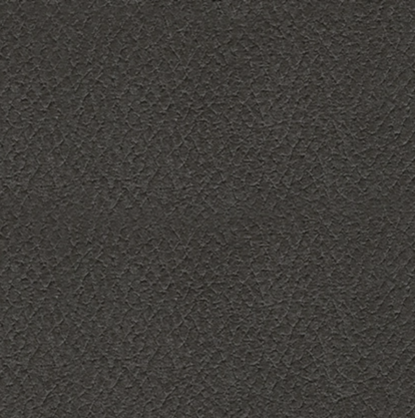 Close-up of dark carbon faux-leather upholstery texture.