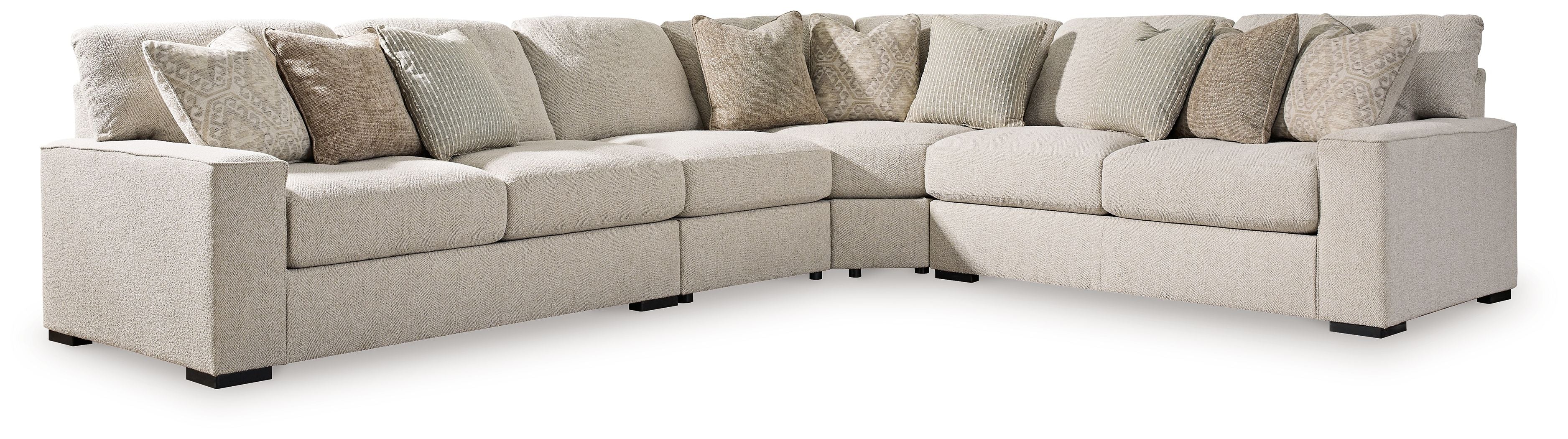 Sand beige sectional sofa with chaise corner, square arms, black feet, and patterned pillows