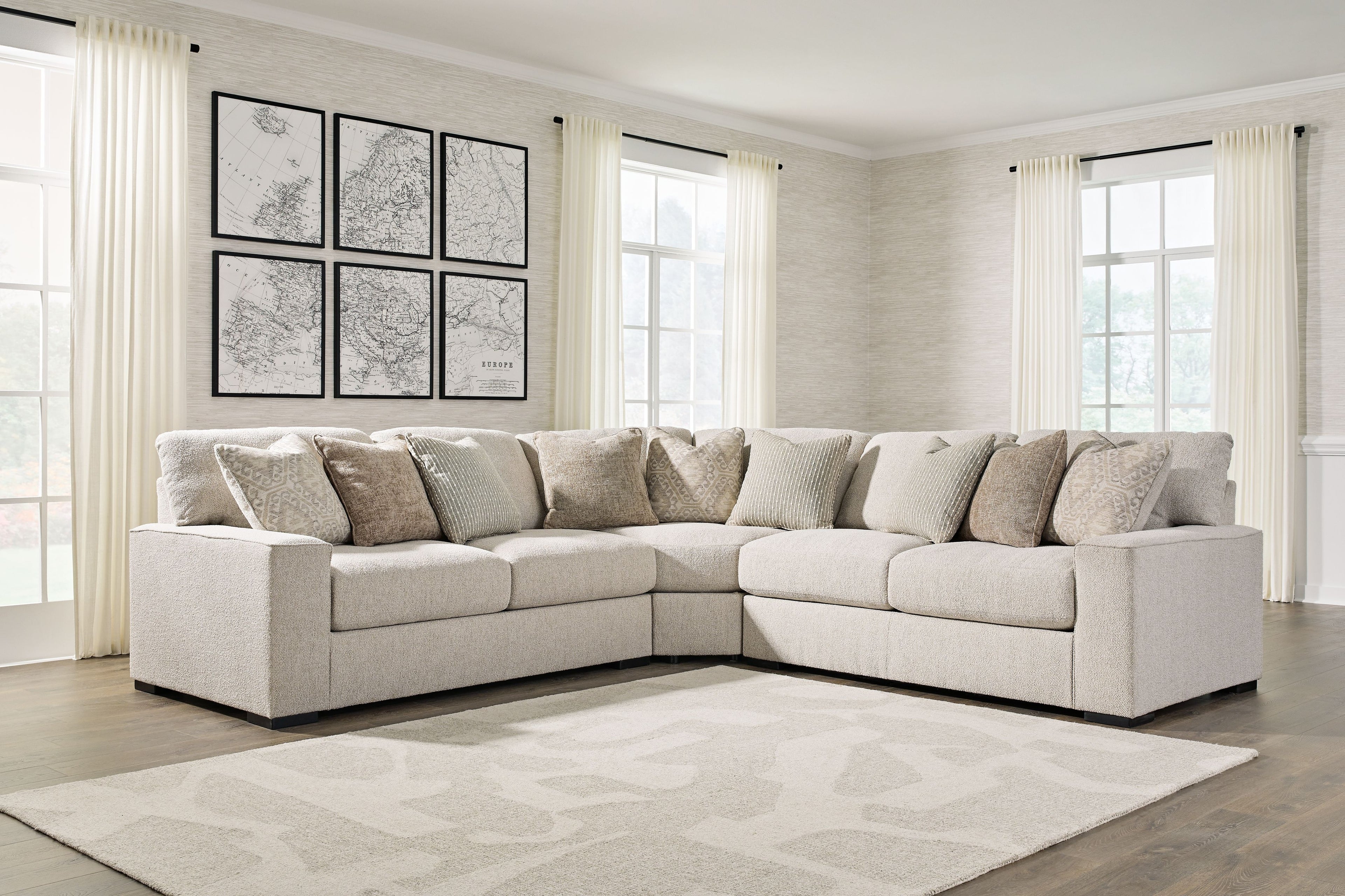 Sand beige sectional sofa with chaise corner and patterned throw pillows, black feet
