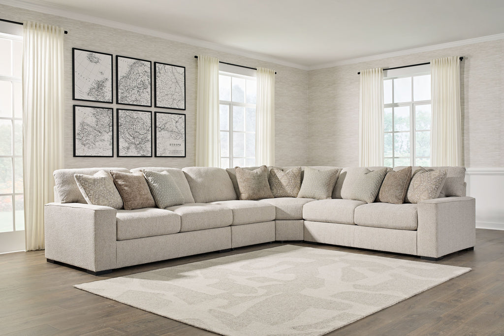 Sand beige sectional sofa with chaise corner and patterned pillows, tufted seat and back cushions