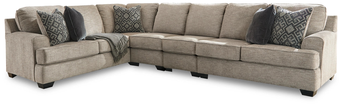 Stone corner sectional sofa with multiple back cushions and patterned accent pillows