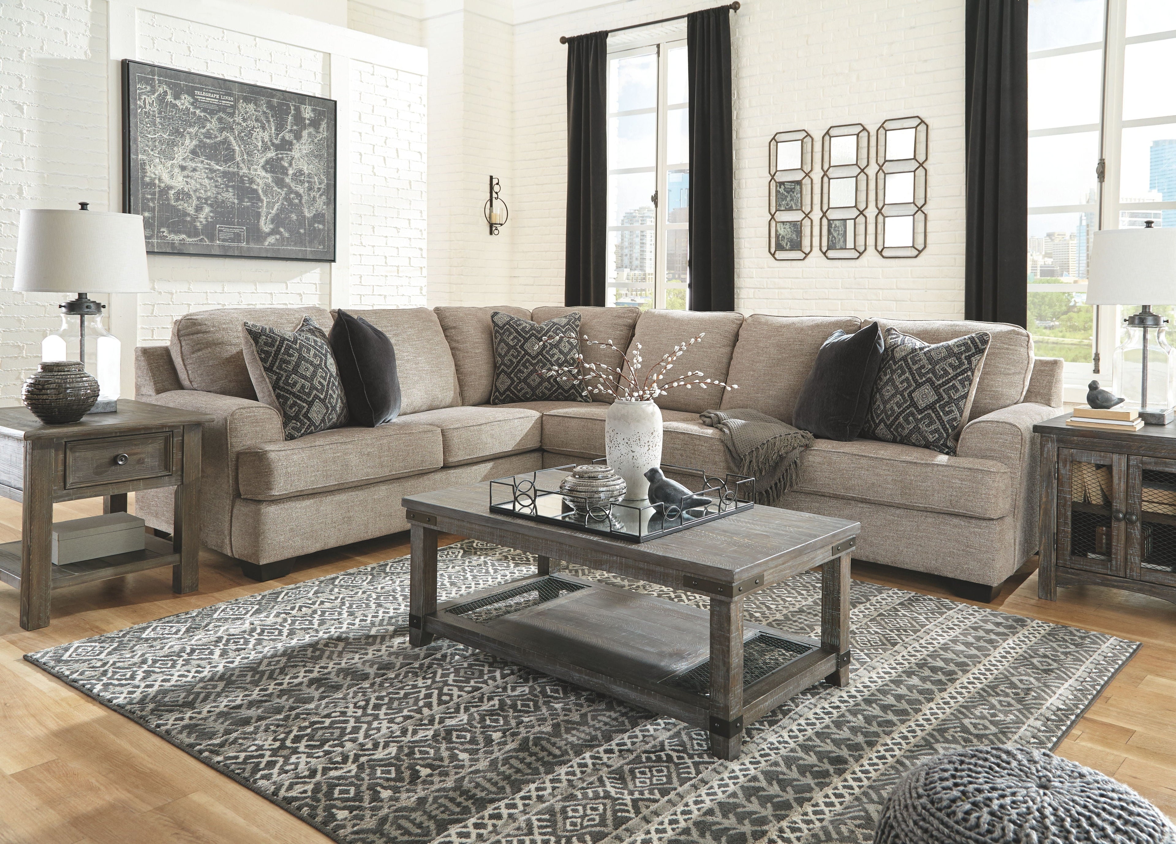Stone sectional sofa with patterned accent pillows and matching area rug in front