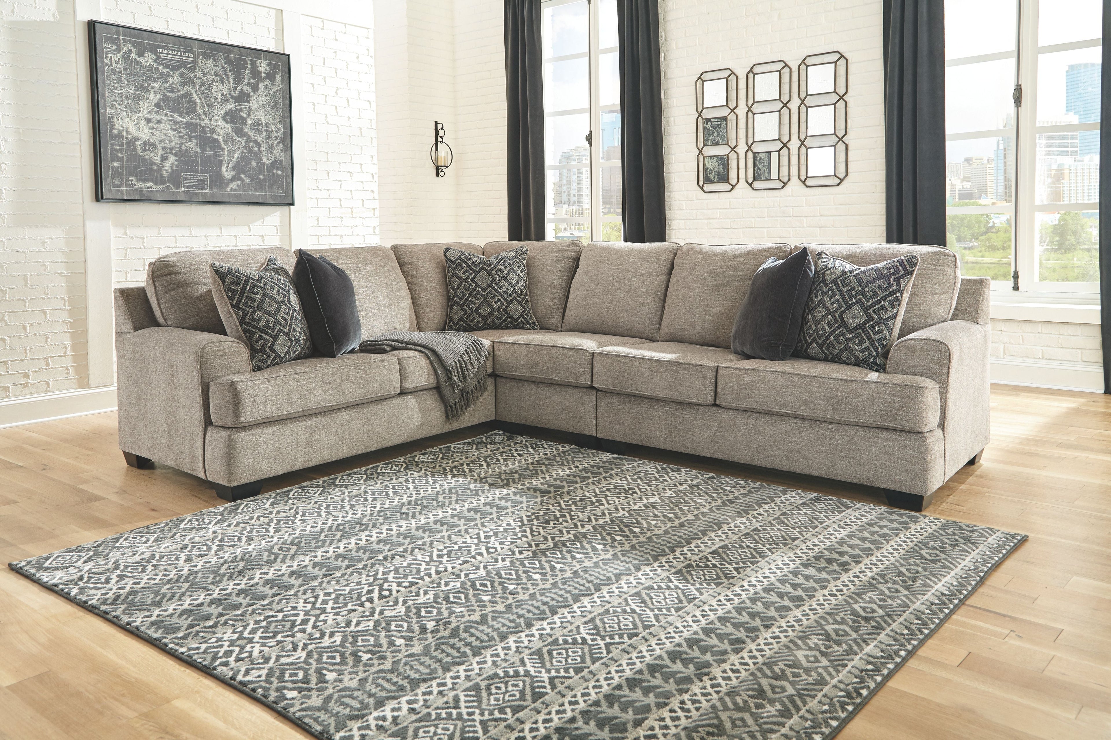 Stone fabric sectional sofa with patterned throw pillows and chaise corner layout