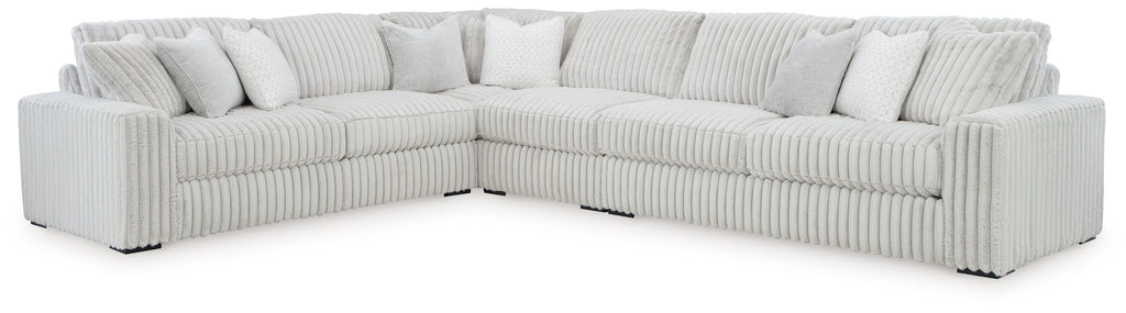 Light gray corner sectional sofa with three seat cushions and ribbed arm panels