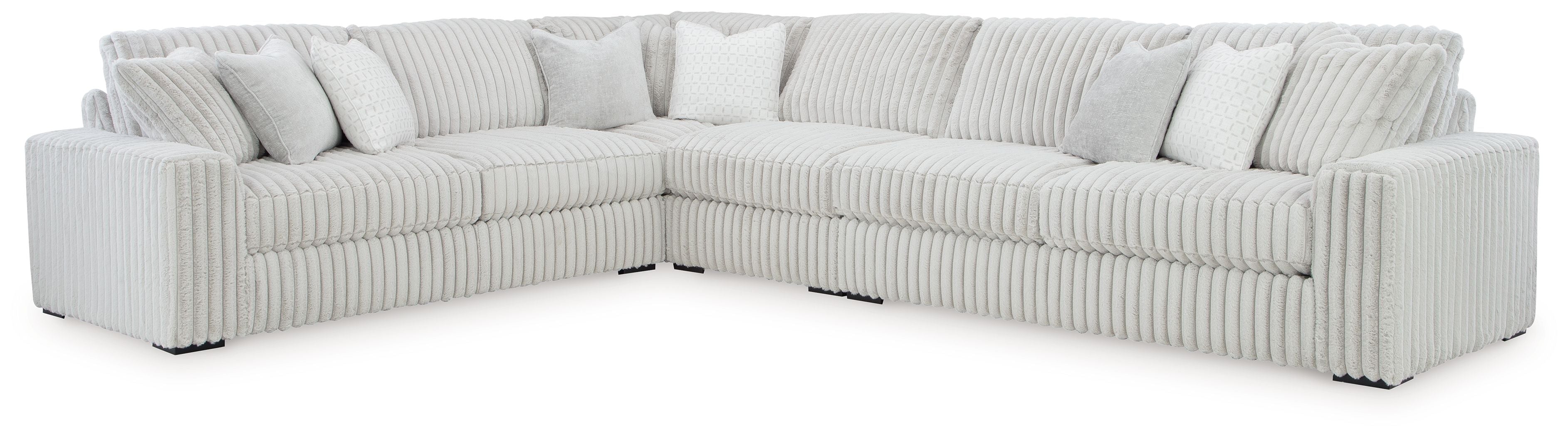 Light gray corner sectional sofa with three seat cushions and ribbed arm panels