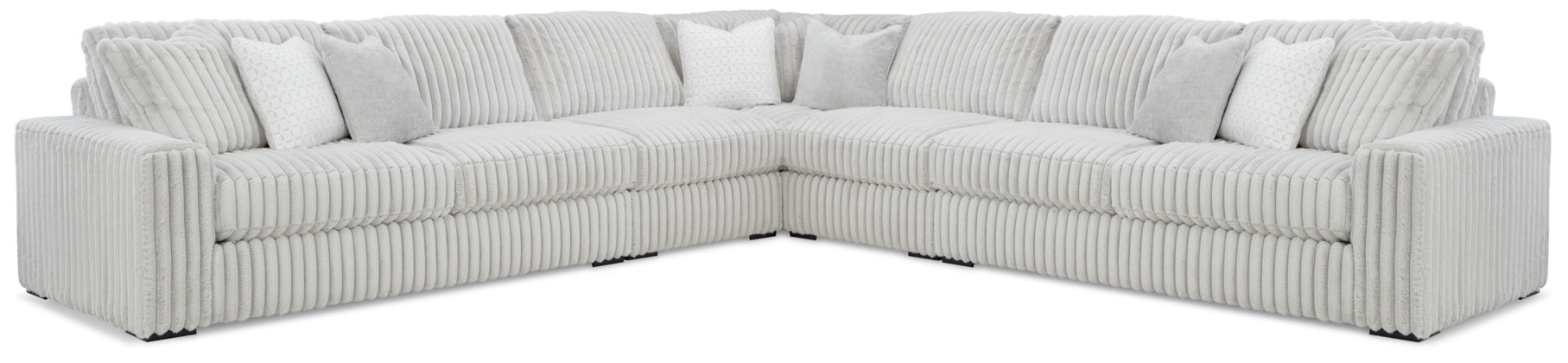 Light gray sectional sofa with corner wedge and backrest pillows, ribbed upholstery