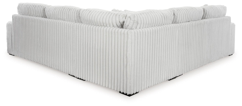 Light gray sectional sofa corner with vertical ribbed sides and tight seat cushions