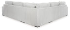 Light gray sectional sofa corner with vertical ribbed sides and tight seat cushions