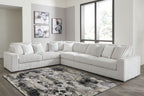Light gray sectional sofa with multiple back pillows and ribbed chaise seating