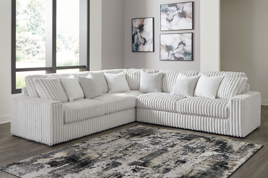 Light gray sectional sofa with corner chaise and ribbed tufted cushions