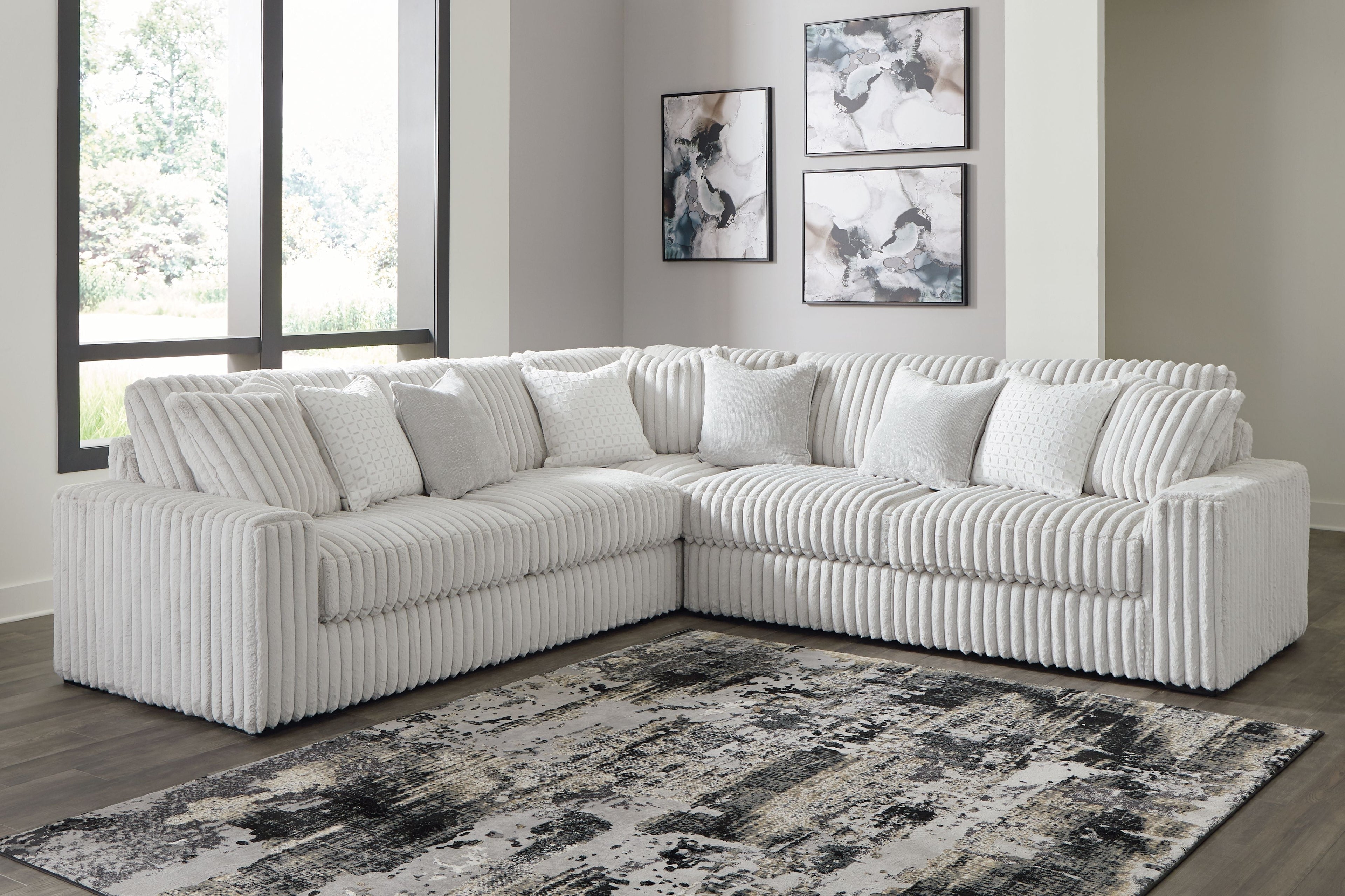 Light gray sectional sofa with corner chaise and ribbed tufted cushions