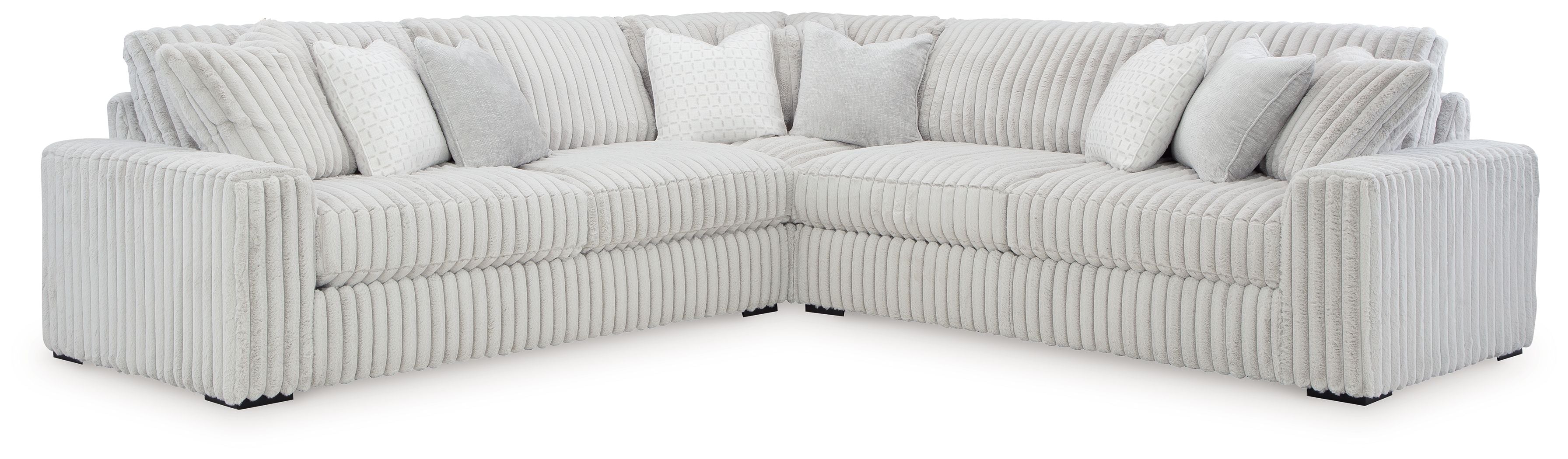 Light gray sectional sofa with tufted back cushions and ribbed upholstery, corner chaise