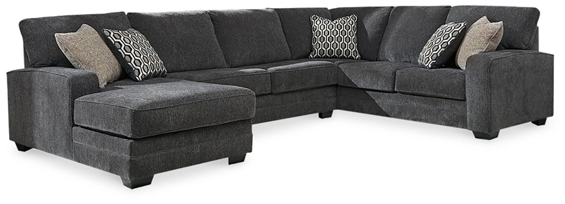Dark gray sectional sofa with left-facing chaise, padded armrests, and throw pillows