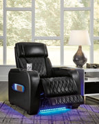 Black power recliner with quilted seat, adjustable headrest, and blue LED accent lights