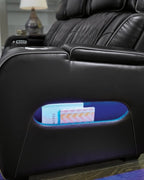 Black recliner arm storage with blue LED light glowing inside the compartment