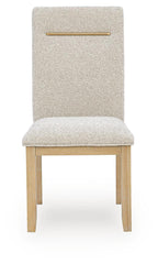Light beige upholstered dining side chair, close front view, wooden legs and gold bar