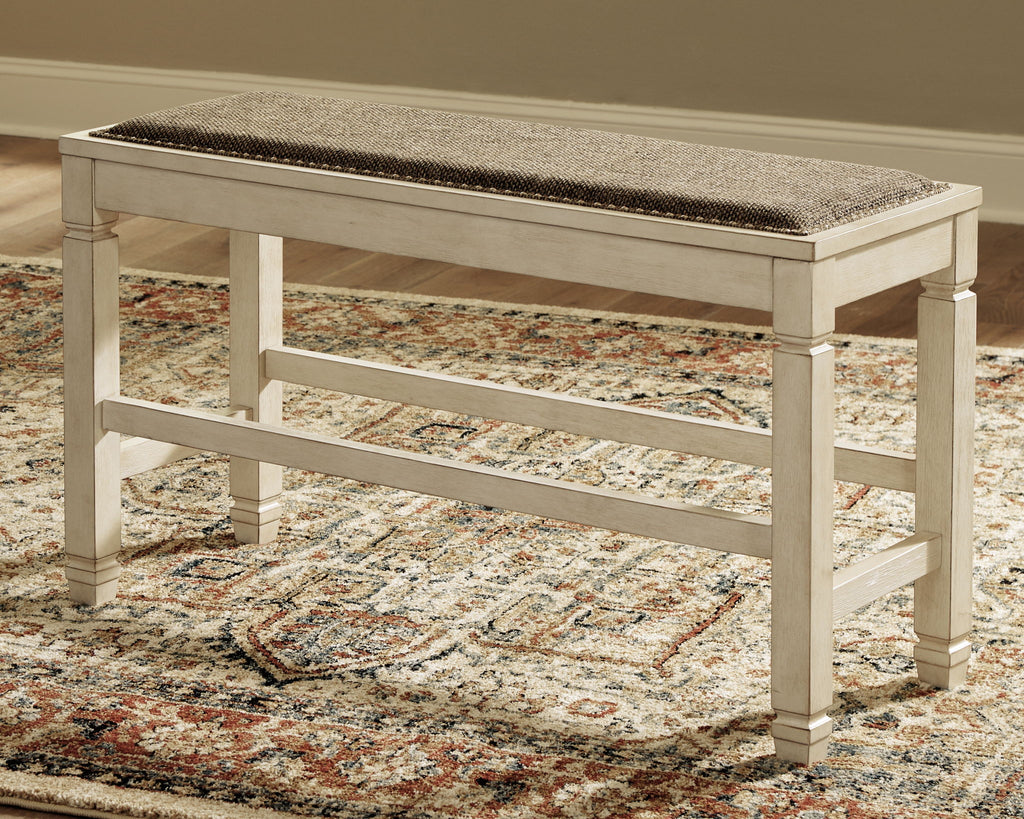Beige counter bench with upholstered seat and open lower shelf underframe