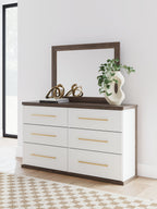 Six-drawer dresser with mirror and white drawers, warm wood top, gold bar pulls.