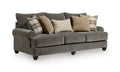 Tallow Creek sofa in dark gray upholstery with tufted back and arms, with plaid throw pillows