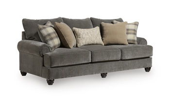 Tallow Creek sofa in dark gray upholstery with tufted back and arms, with plaid throw pillows