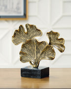 Gold-finish abstract leaf sculpture with dark gray square base