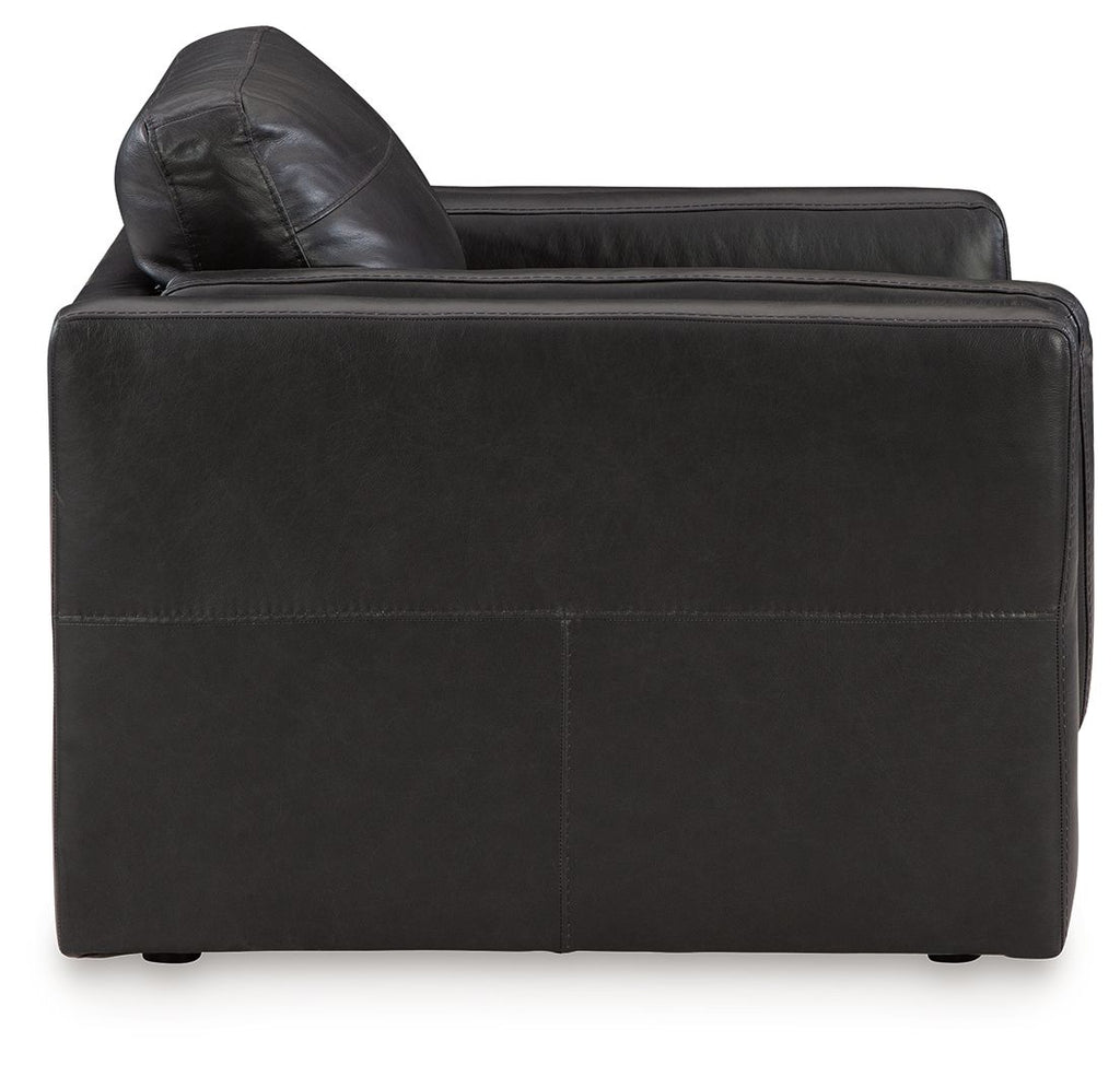 Black leather accent chair with curved back and thick seat cushion