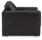 Black leather accent chair with curved back and thick seat cushion