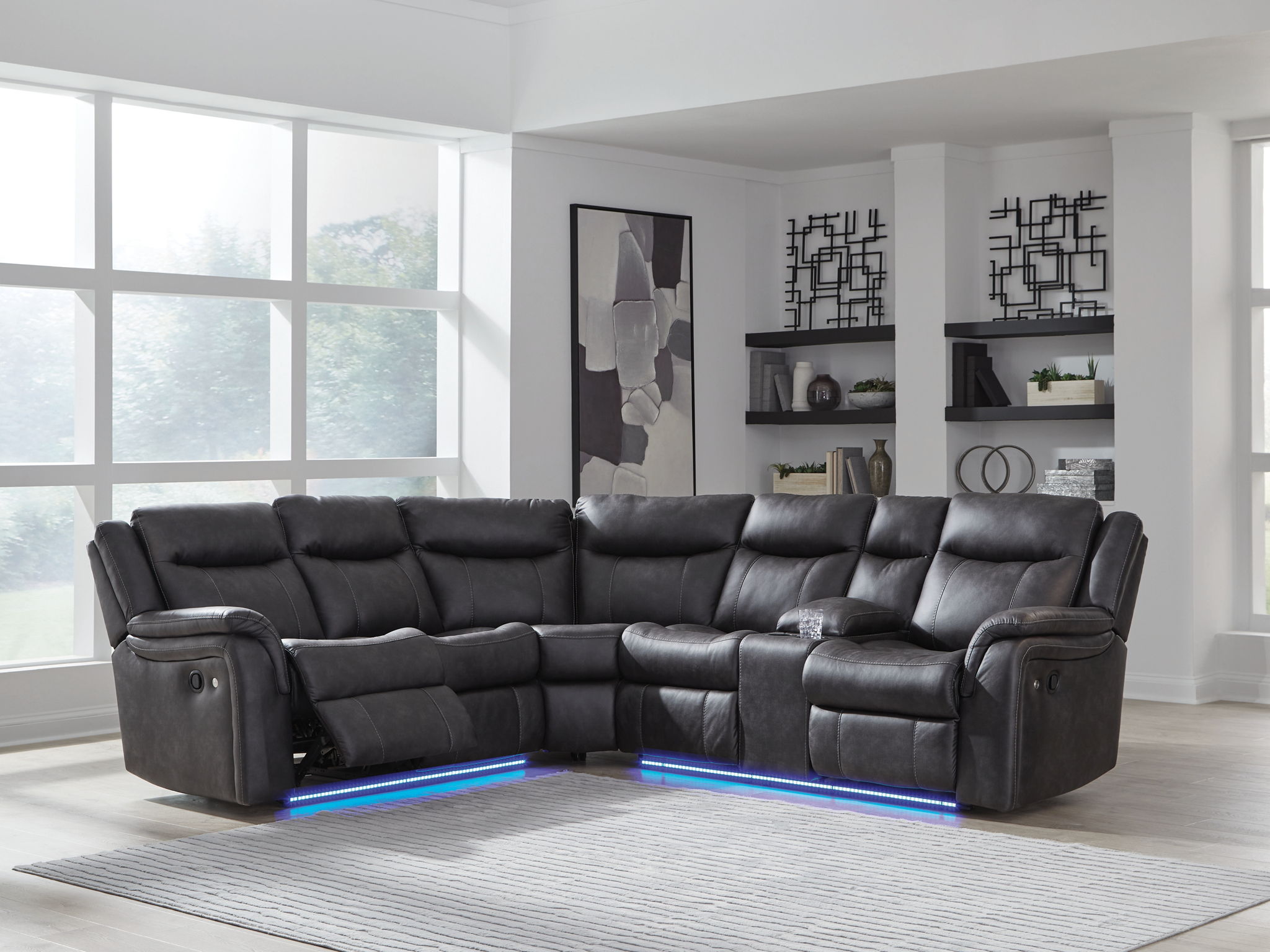 Dark carbon reclining sectional sofa with cushioned arms and visible chaise/sectional connections.