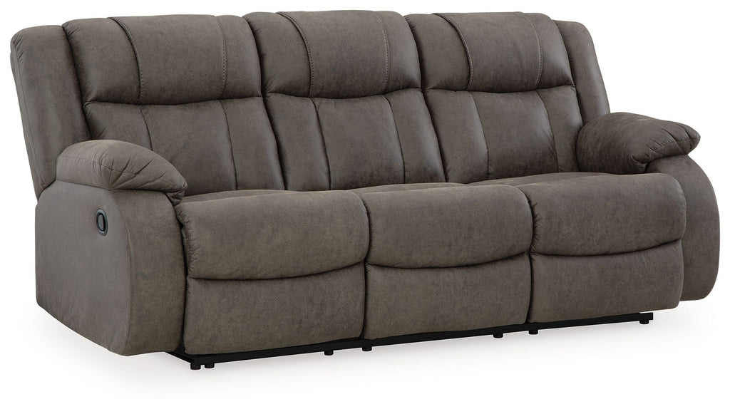 Gunmetal reclining sofa with tufted back, padded headrest, and arm recliner