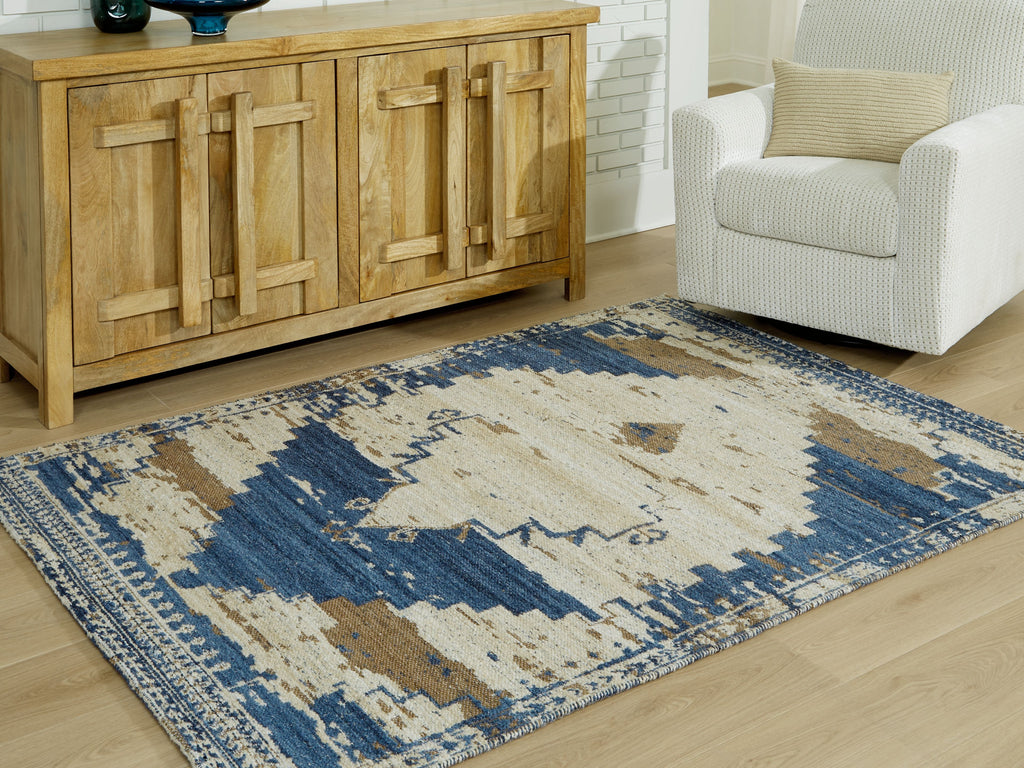 Geometric area rug in cream and blue with distressed design and patterned border