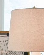 Beige fabric drum lamp shade with brass-colored top cap