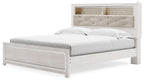 White king bookcase panel bed with upholstered headboard and wide foot drawer
