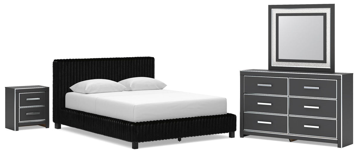 Black upholstered bed with nightstand and dresser with large framed mirror