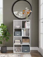White cube organizer with 9 open cubbies containing books and small storage bins