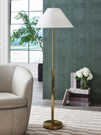 Gold floor lamp with white shade, round base, and two hanging pull cords.