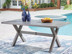 Gray rectangular dining table with decorative items on top