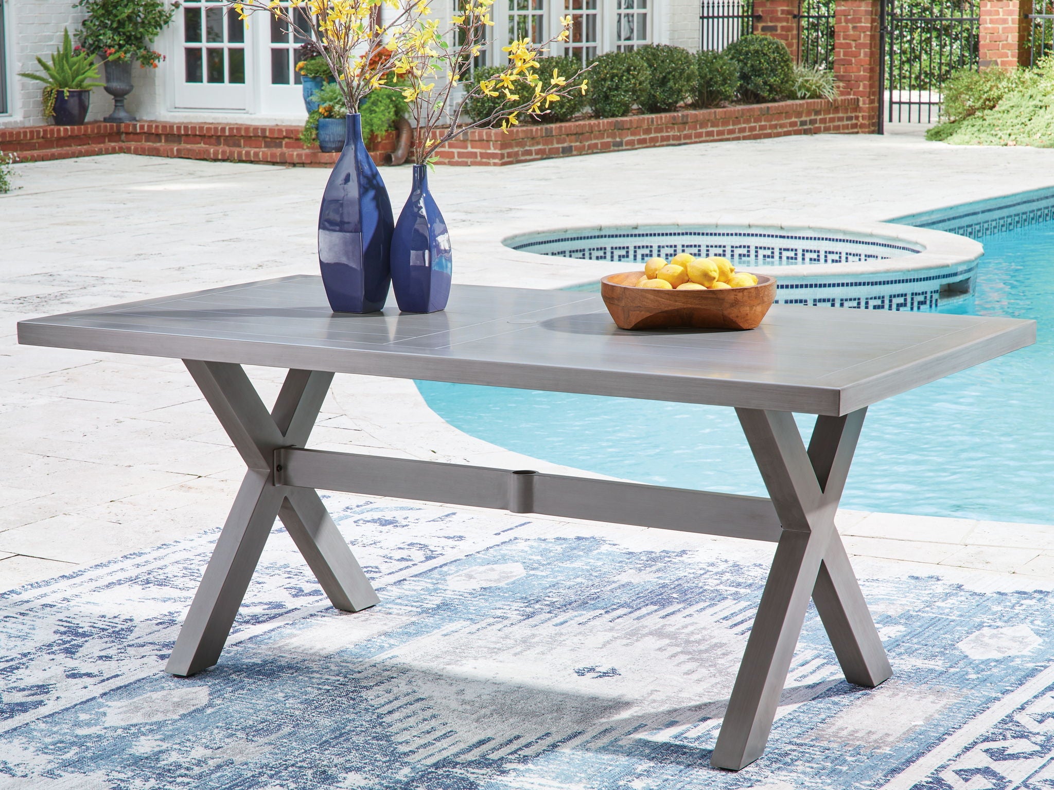 Gray rectangular dining table with decorative items on top