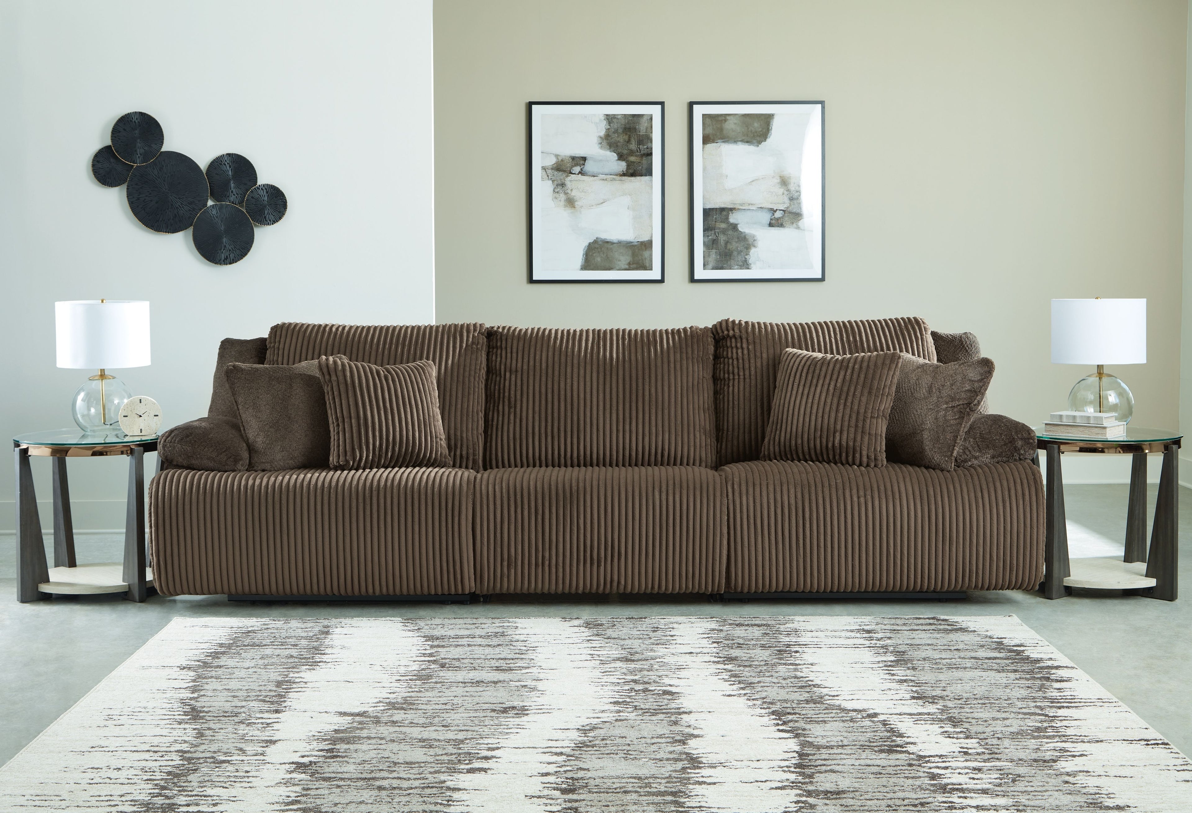 Chocolate brown reclining sectional sofa with striped seats and back cushions