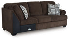 Chocolate-brown upholstered sofa with corner wedge and two geometric throw pillows