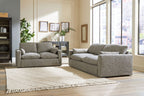 Two-piece gray living room seating set with sofa and loveseat, plus ottoman