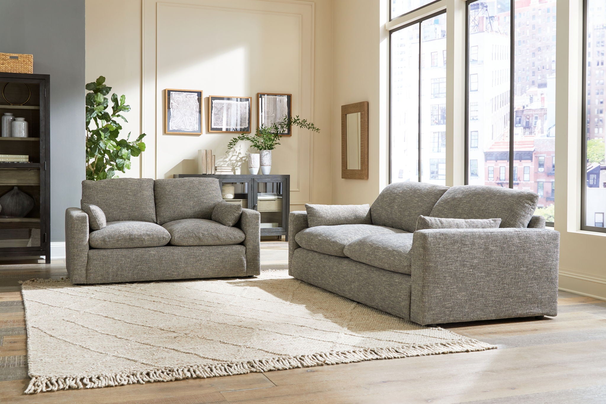 Two-piece gray living room seating set with sofa and loveseat, plus ottoman