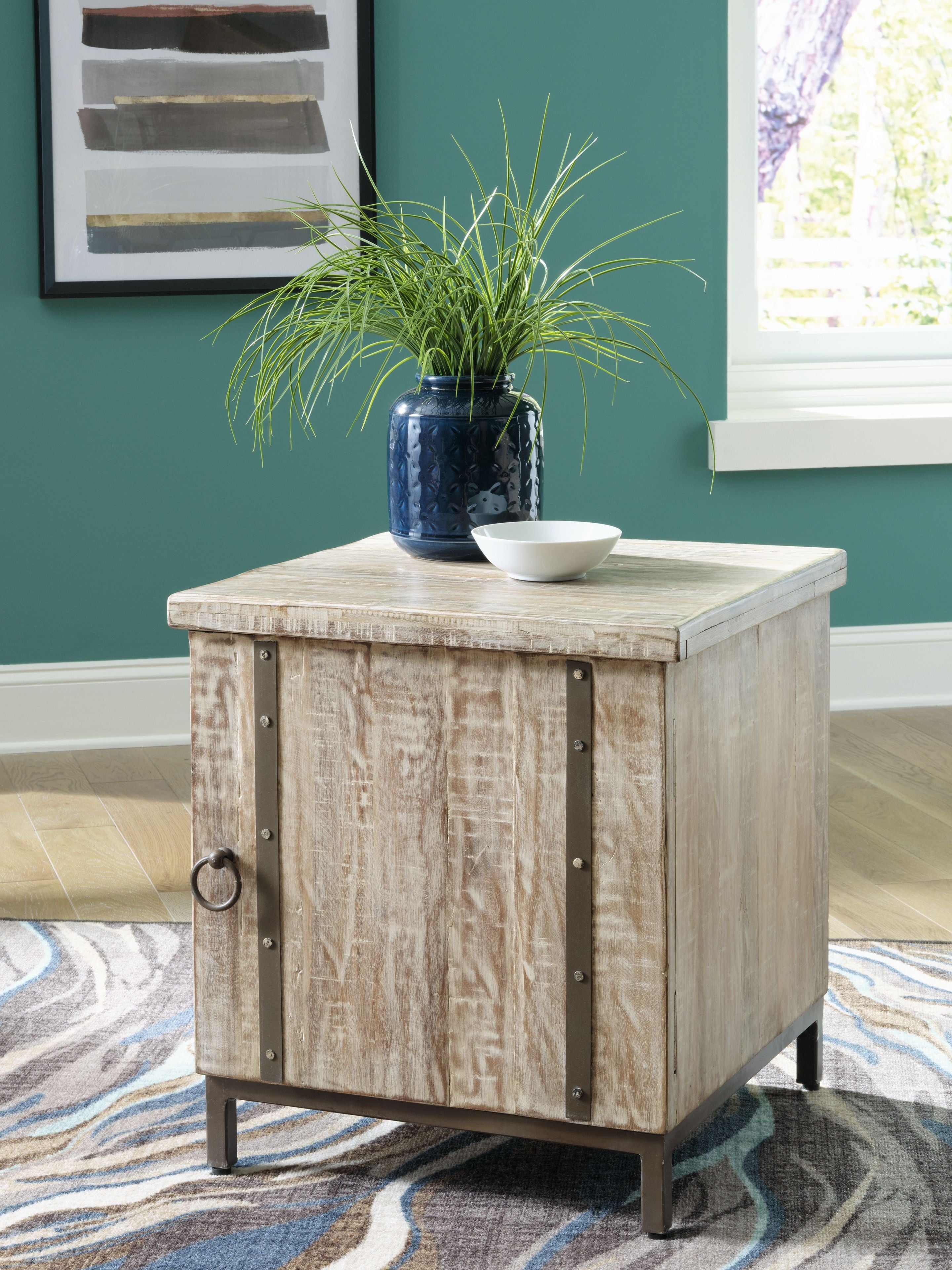 Whitewashed accent cabinet with tabletop, paneled sides, and dark metal corner brackets