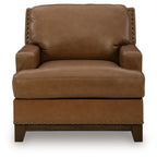 Amber leather armchair with nailhead trim, cushioned seat, and tall backrest