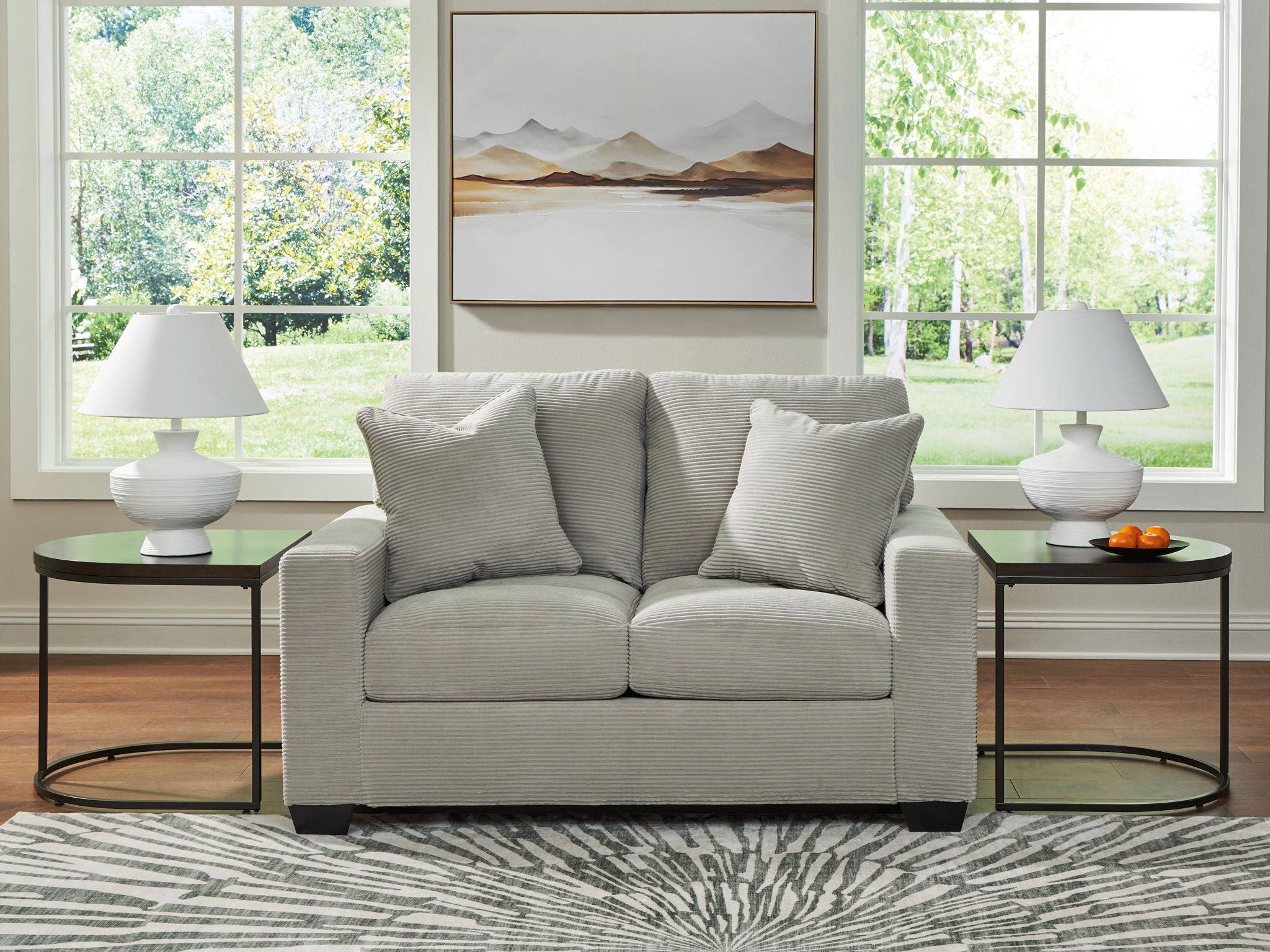 Light upholstered loveseat with four throw pillows and two seat cushions