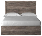 Dark gray wood panel bed with rectangular headboard, centered gray mattress and pillows