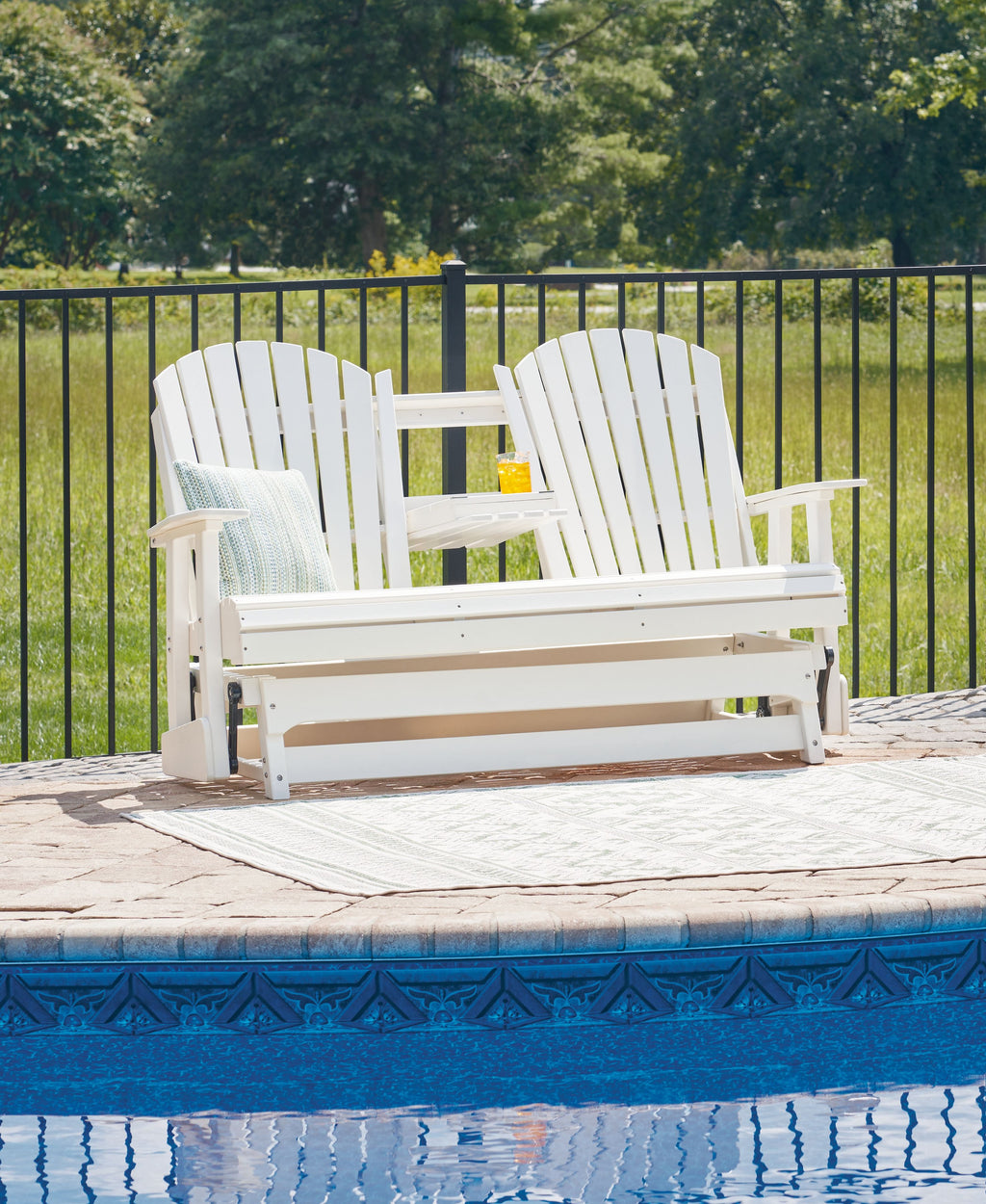 White outdoor glider loveseat with curved slat back and wide bench seat